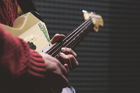 close-up photo of person playing guitar thumbnail