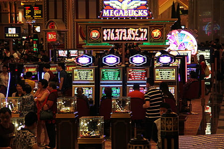 man walking in front of slot machines thumbnail
