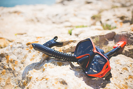 Snorkel and Diving Scuba Mask On a Rock Near The Sea thumbnail