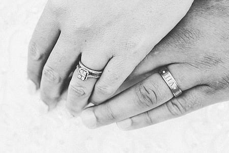 grayscale photography of two hand wearing ring thumbnail