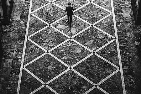 grayscale photography of person walking on soil thumbnail
