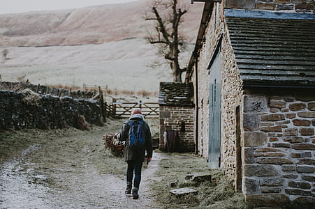 person walking beside the house thumbnail