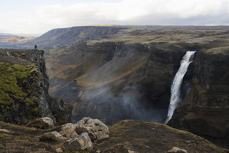 aerial photography of water falls between mountain range thumbnail