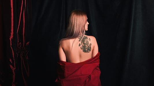 women's red top with tattoo on her back thumbnail