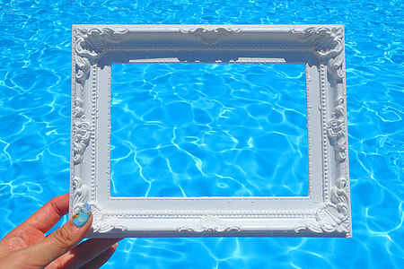 person holding rectangular ceramic flame near pool thumbnail