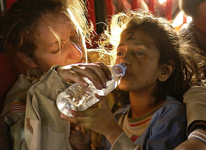 woman helping the girl drinking water on plastic bottle thumbnail