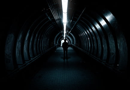 silhouette of person standing inside tunnel thumbnail