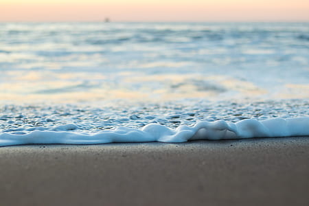 sea water on brown shore at daytime thumbnail