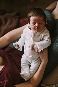 woman carrying sleeping baby thumbnail