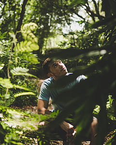 man sitting in the middle of the forest thumbnail