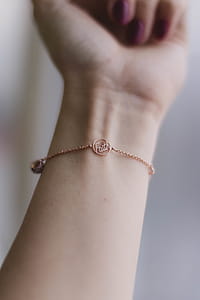 Person Wearing Pink Gold-colored Faith Bracelet thumbnail
