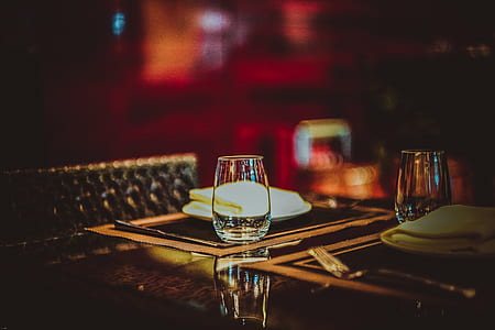 two clear drinking glasses on table thumbnail