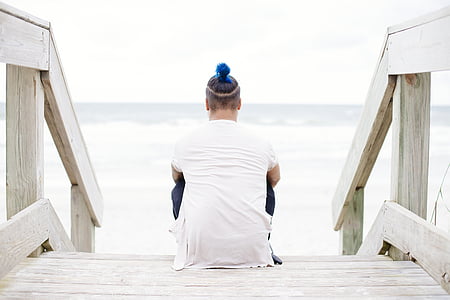 person sitting on white wooden staircase thumbnail