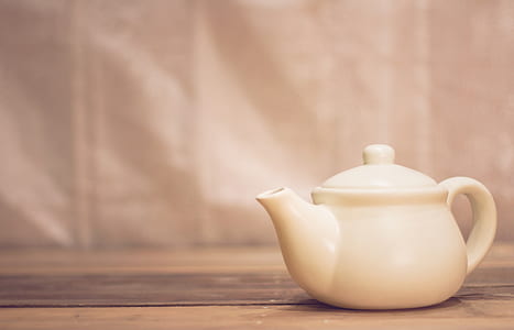 white ceramic teapot on brown surface thumbnail