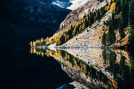 mirror photography of mountain near body of water thumbnail