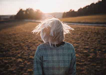 close-up photo of person waving hair at golden hour thumbnail