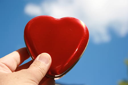 person holding red heart case thumbnail