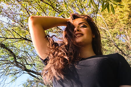 Low Angle View of Woman Holding Her Hair thumbnail