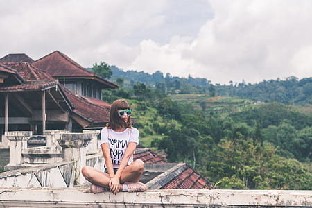 woman sitting on gray concrete ledge thumbnail