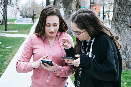 Photography of Women Using Mobile Phones thumbnail