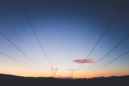 silhouette photography of transporter tower near trees thumbnail