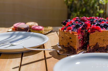 Cake Near White Ceramic Plate on Brown Wooden Table thumbnail