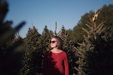 selective focus photography of woman surrounding plants thumbnail