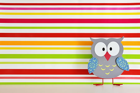 gray owl cutout decor standing near multicolored striped wall thumbnail