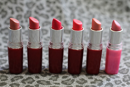 six assorted lipsticks on gray leopard print textile thumbnail