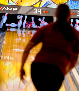 woman paying bowling and hits the bowling pins thumbnail