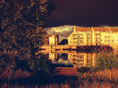 brown buildings next to river thumbnail