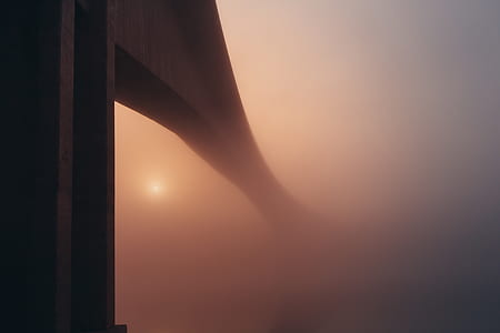 low angle view of gray bridge coated by clouds thumbnail