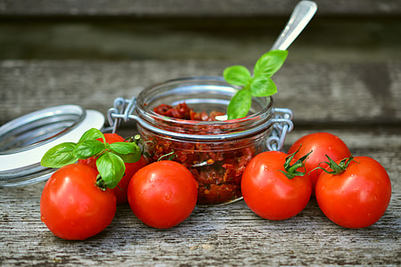 tomatoes and airtight jars with chili inside thumbnail