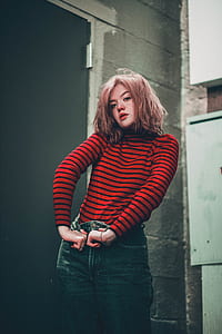 woman in striped sweater standing beside black flush door thumbnail