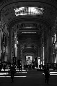 grayscale photography of people standing inside concrete building thumbnail