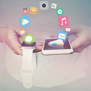 person holding gold iPhone 6 with silver Apple Watch thumbnail