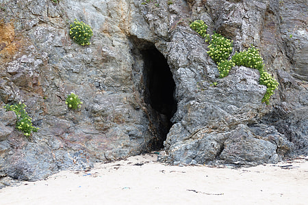 grey fault-block mountain with narrow cave entrance during daytime thumbnail
