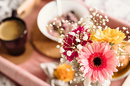 shallow focus photography assorted-color flowers beside mug and bowl on tray thumbnail
