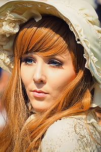 closeup photo of woman wearing beige floral hat thumbnail