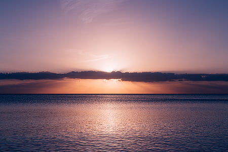 calm body of water during golden hour thumbnail