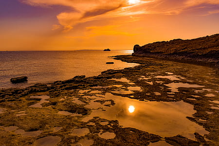 rock formation on body of water thumbnail