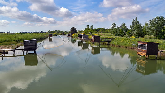 brown wooden pet cage near the body of water thumbnail