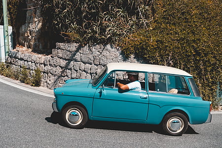 man riding blue 3-door hatchback on road at daytime thumbnail