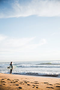 Surfer Standing By Ocean Photo thumbnail