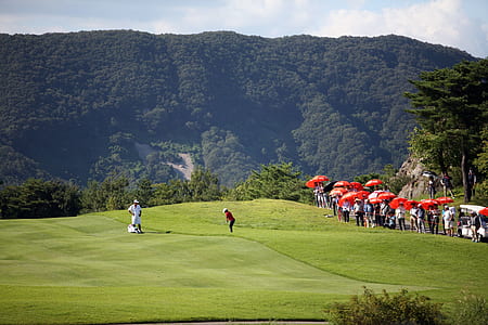 two people playing golf in golf course thumbnail