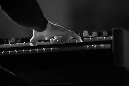 person playing keyboard grayscale photography thumbnail