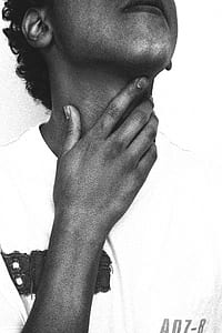 grayscale photography of person holding his neck and wearing crew-neck shirt thumbnail