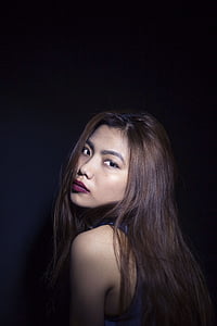 brown haired woman wearing blue sleeveless top thumbnail