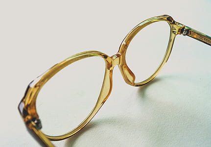Yellow Frame Eyeglasses on White Surface thumbnail