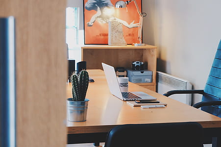 white laptop computer on wooden desk thumbnail